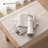 Pack & Press™ space-saver kit with portable pump and vacuum compression bags on a table